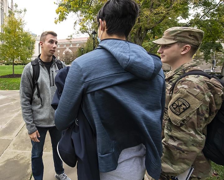 Matthew Starinksy speaking to an ROTC cadet and a recruit