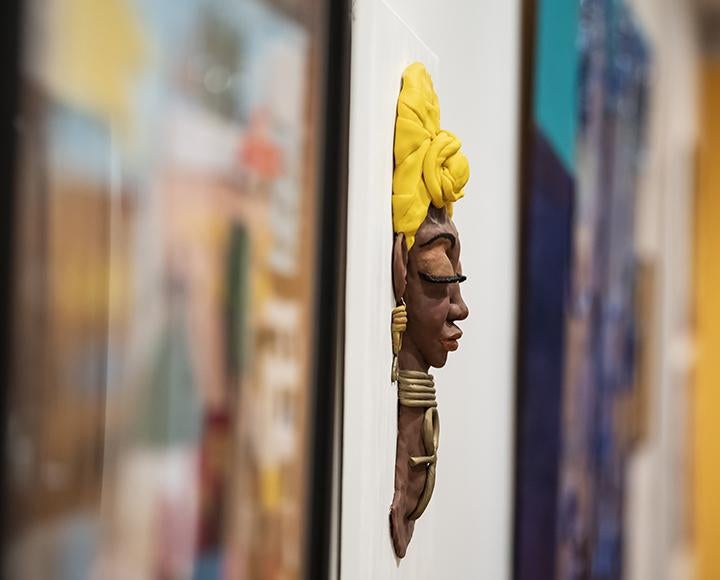Sculpture of a woman wearing a yellow headwrap