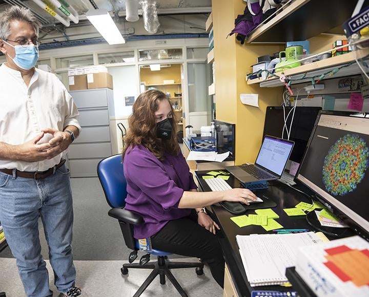 Graham Hatfull and Krista Freeman looking at computer screen in lab
