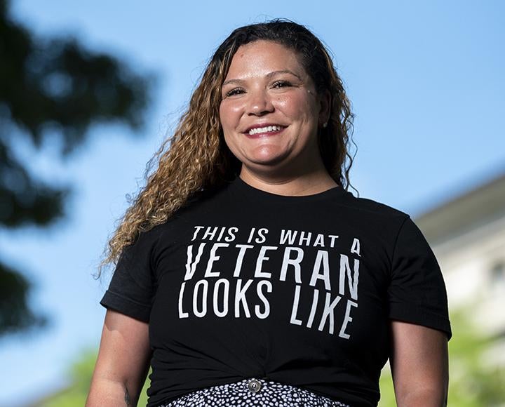 a woman in a black shirt that says "This is what a veteran looks like"