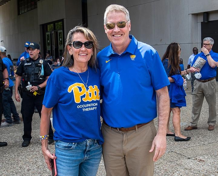 the chancellor and a staff member in Pitt shirts