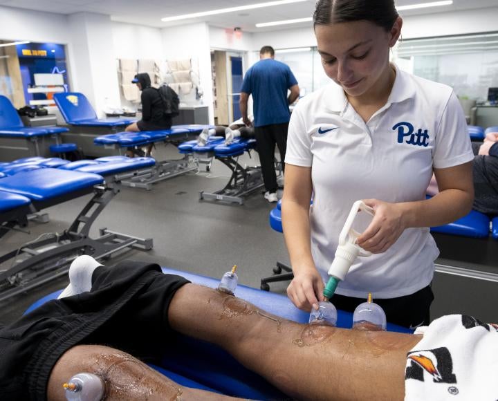 an athletic trainer works with a student