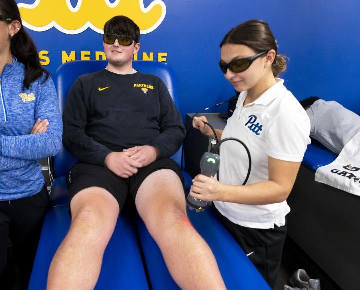 athletic trainers work with a patient
