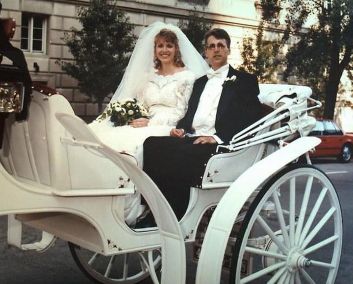 A bride and groom ride in a carriage