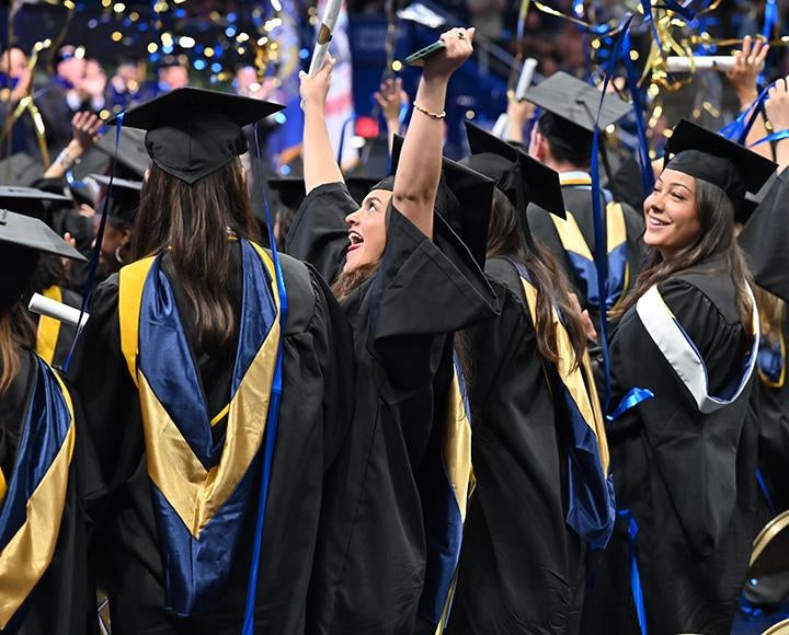 Graduates celebrate as confetti falls