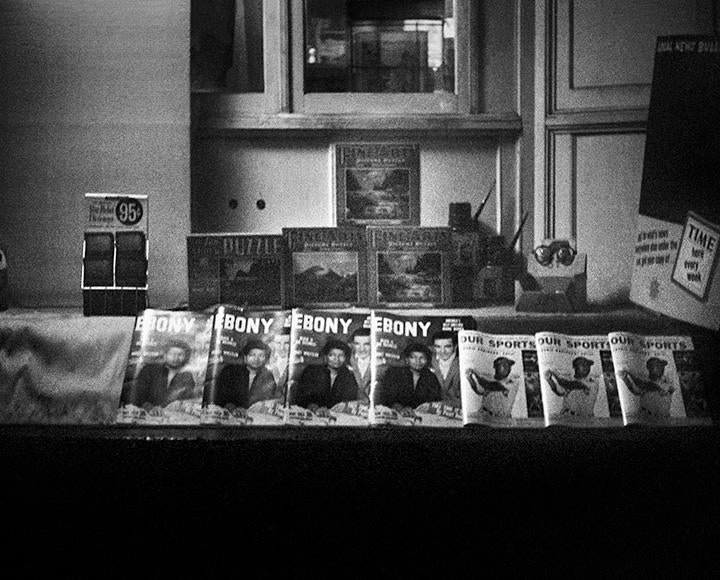 A black and white photo of magazines on display in the University bookstore