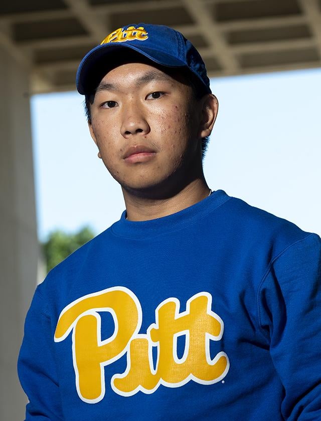 Richard Fang wearing blue Pitt hat and sweater