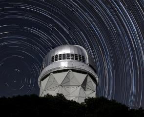 Star trails shown over an observatory at night