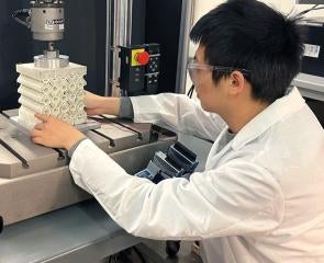a person in a lab coat at a machine