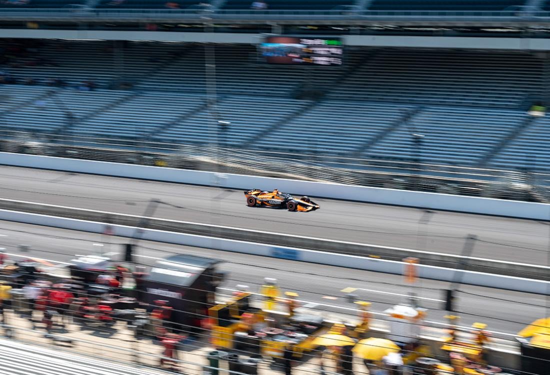 The orange No. 5 car races alone on the track