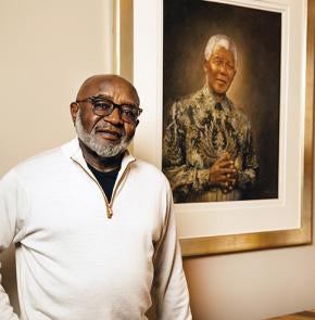 Ware next to a portrait of Nelson Mandela