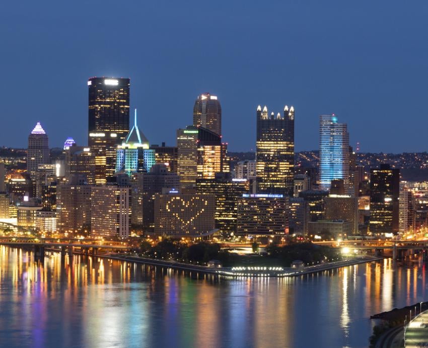 The city of Pittsburgh at night with a heart displayed utilizing a building's windows