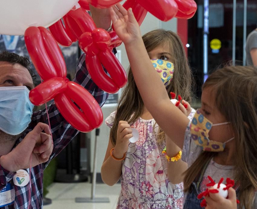 Two children taking part in balloon demonstration 