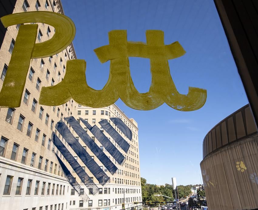 Window art of Pitt in gold text with a blue heart