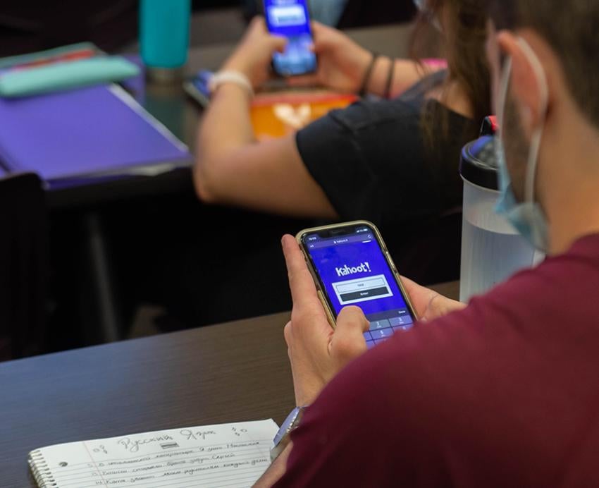 Students using smartphones at desks