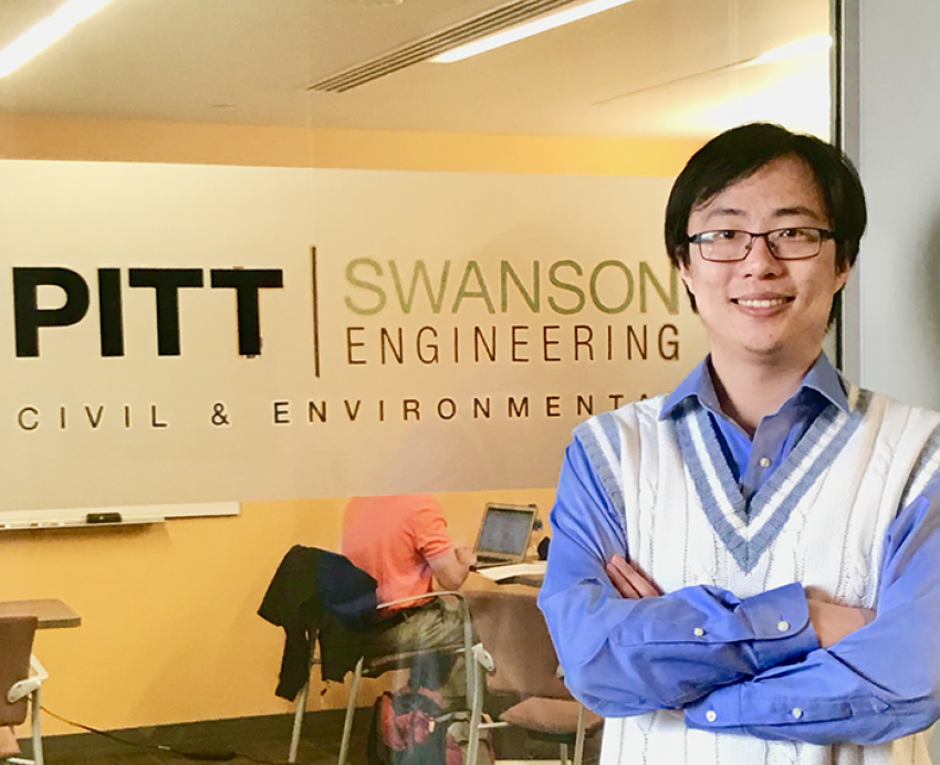 Yunxing Lu standing in front of Pitt Swanson Engineering sign