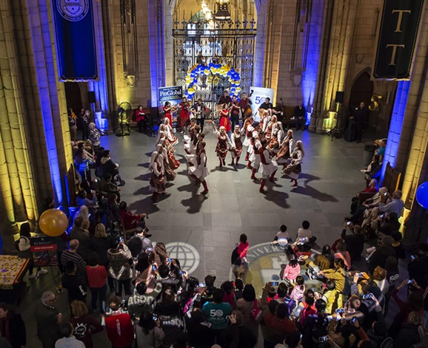Dancers in the Cathedral of Learning with audience gathered around