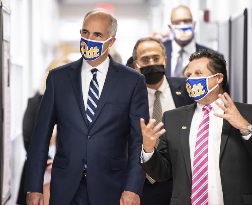 Bob Casey and Paul Duprex walking and talking with face masks