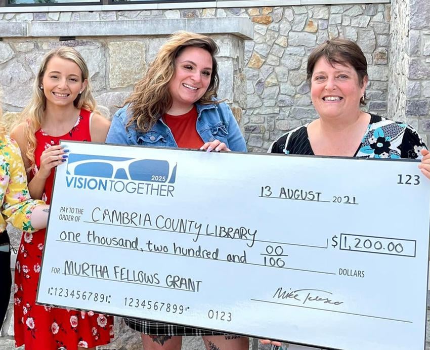 Johnstown group holding large check from Cambria County Library