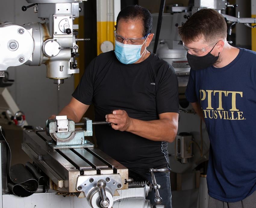 Pitt-Titusville machinists working with machine