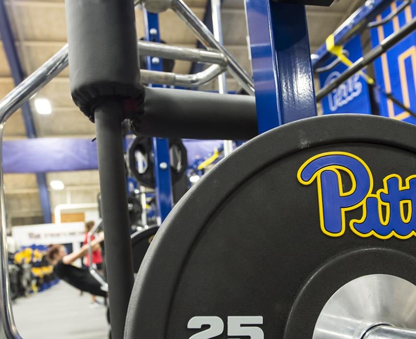 25-pound weight plate with Pitt logo in a gym 