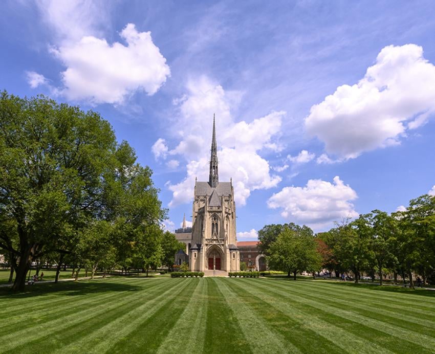 Heinz Chapel behind large field of grass during sunny day