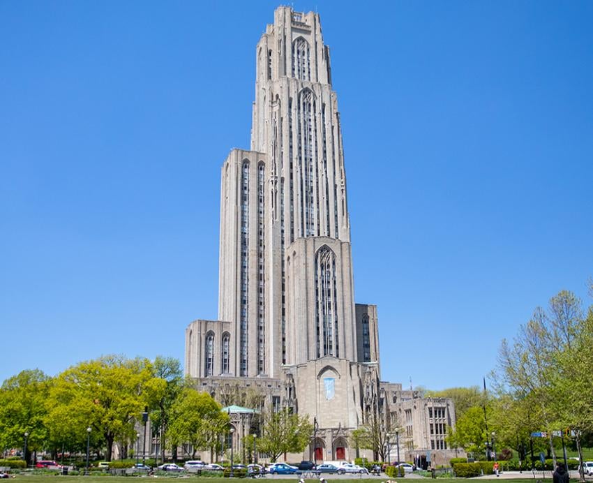 The Cathedral of Learning with surrounding trees during the daytime