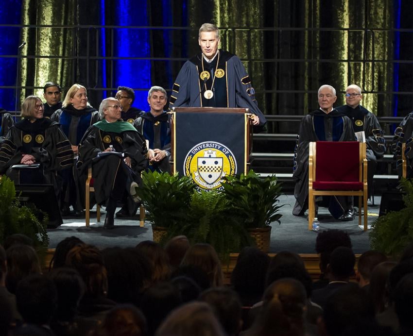 Chancellor Patrick Gallagher speaking at podium during ceremony
