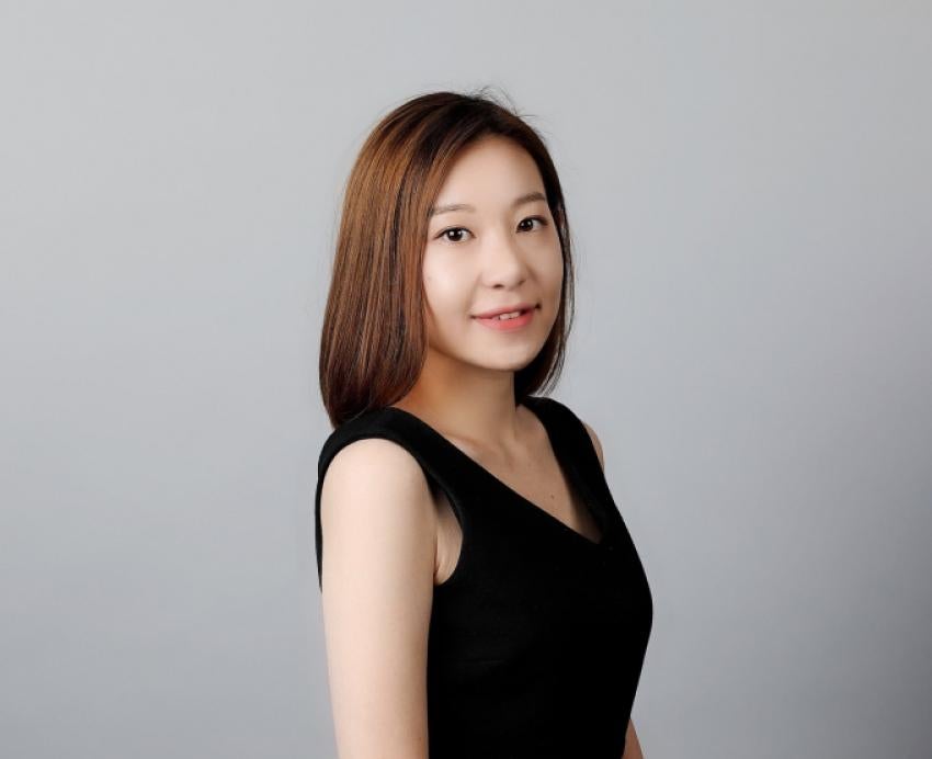 Theresa Kwon in a dark shirt with a grey background