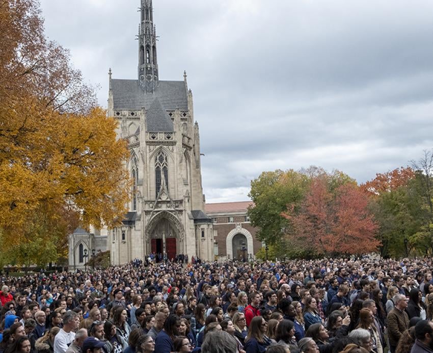 Hundreds of people gathered on lawn in front of Heinz Chapel