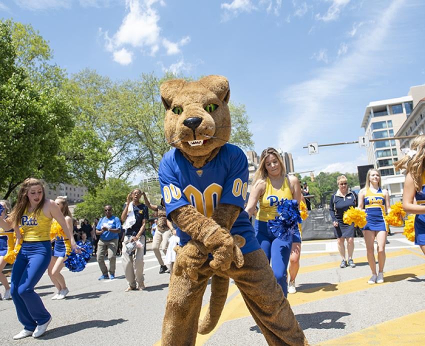 Roc the panther dancing among Pitt cheerleaders in the street