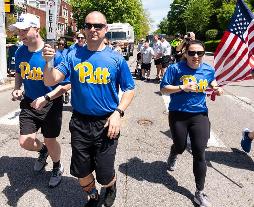 five officers in Pitt shirts jogging