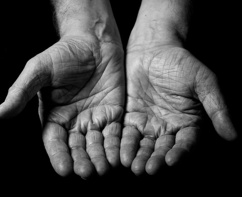 a black and white image of two open hands