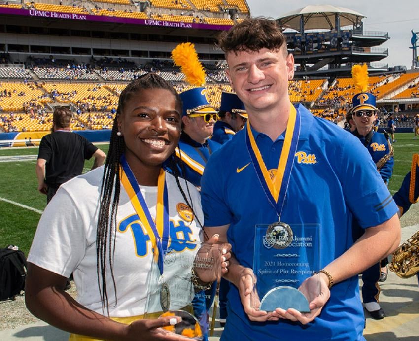 students holding trophies at a football game