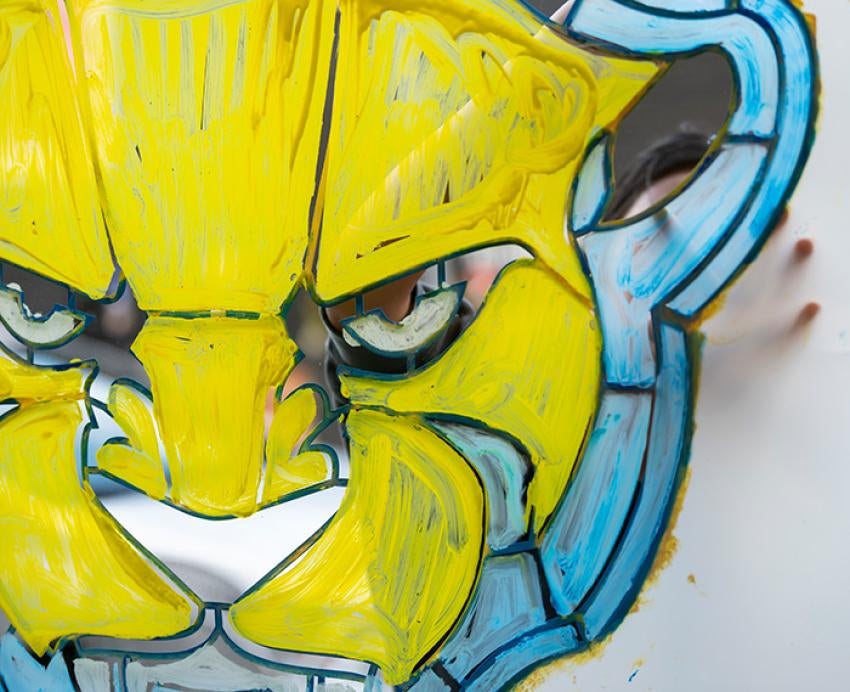A yellow and blue panther painted on a mirror