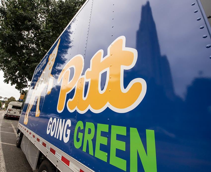 A blue truck that says Pitt Going Green