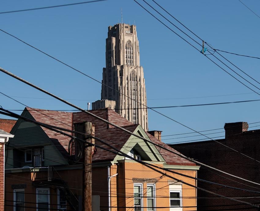 The Cathedral of Learning is seen over rooftops in a Pittsburgh neighborhood