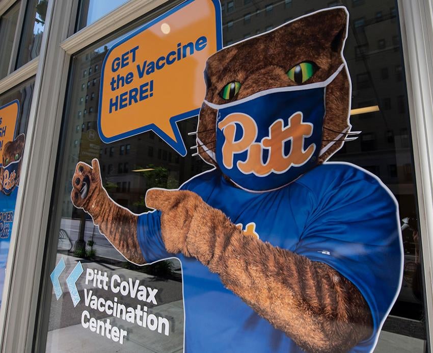 A decal of Roc wearing a mask with a voice bubble that says Get the vaccine here