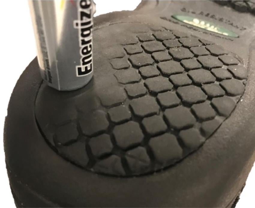 An AA Energizer battery on the bottom of a shoe