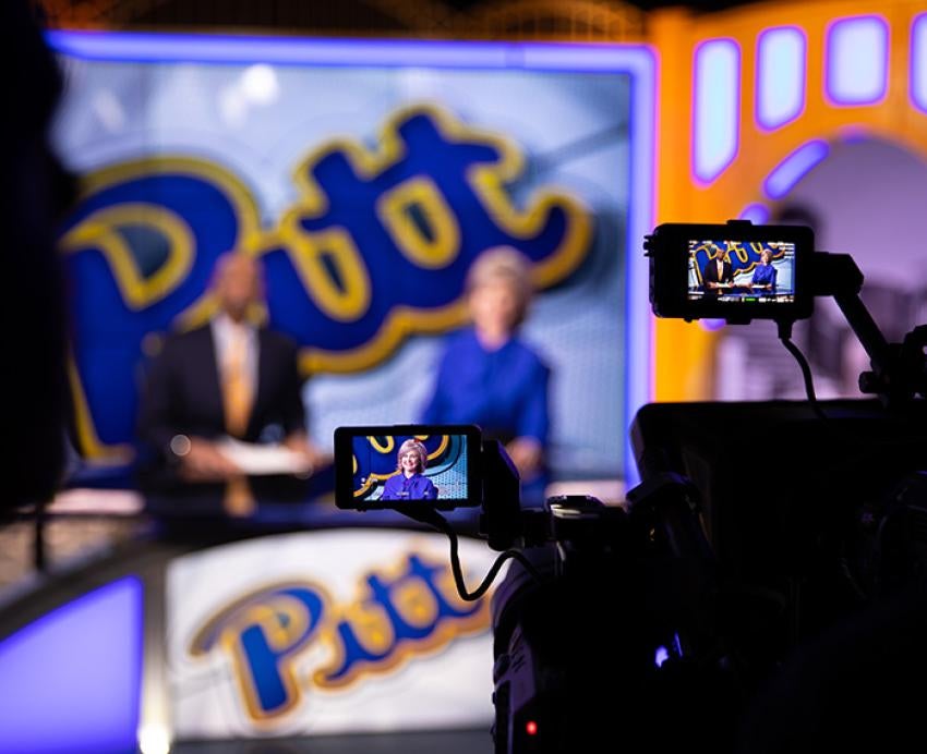 Cameras are pointed at two anchors in the Pitt Studios