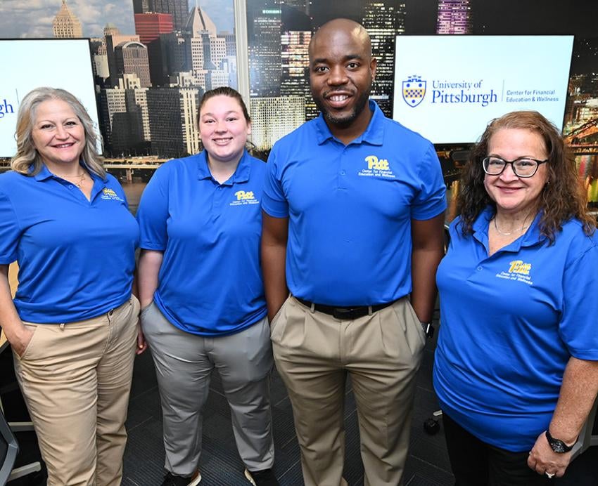 Four employees stand in Pitt's Center for Financial Education and Wellness
