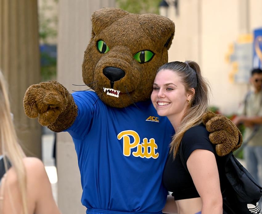 a student poses with Roc