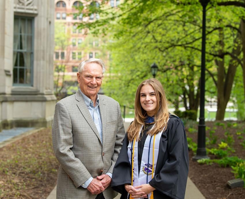 Jim Zurcher stands with Chloe Davis, who wears graduation robes and cords