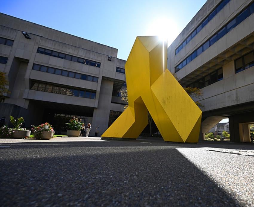 A large yellow sculpture outside Posvar Hall