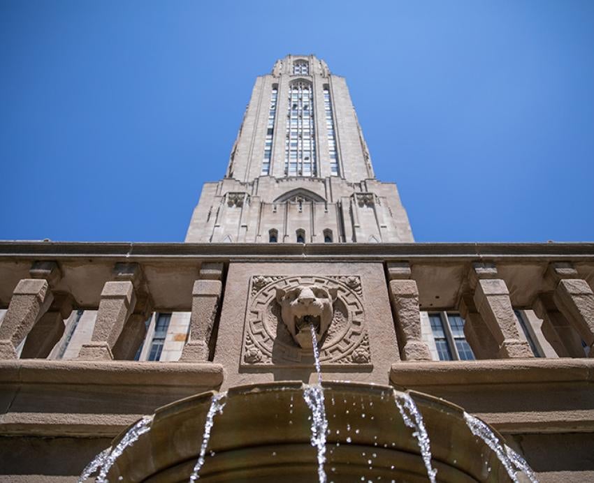 Water pours from a panther fountain on the Cathedral of Learning