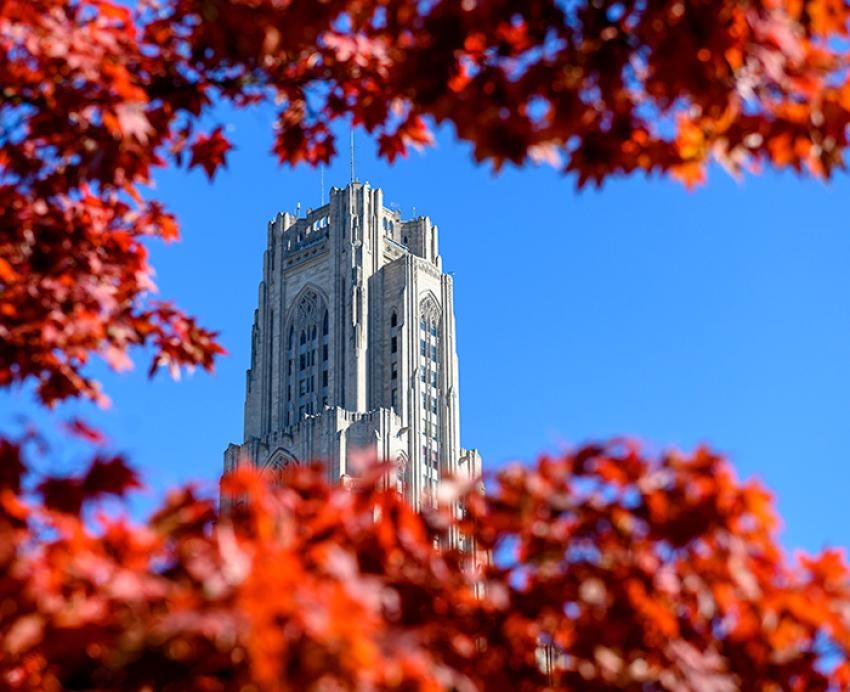 The Cathedral of Learning behind red leaves