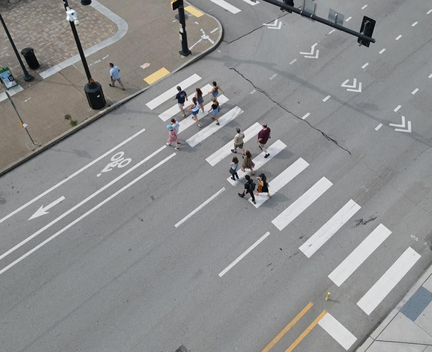A drone shot of people using a crosswalk