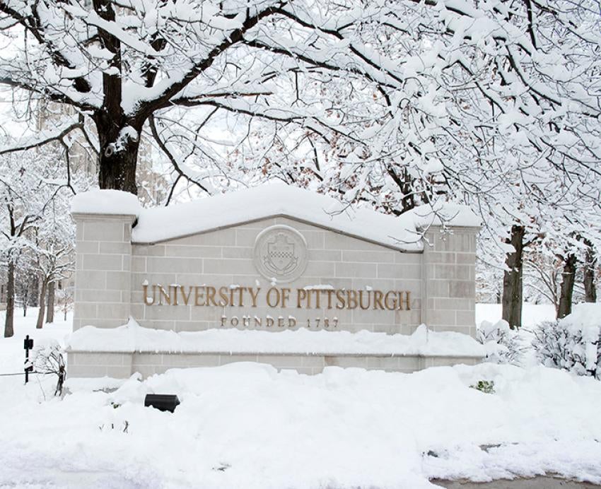The University of Pittsburgh entrance sign on a snowy day