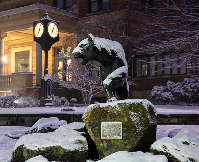 A snow-covered panther statue