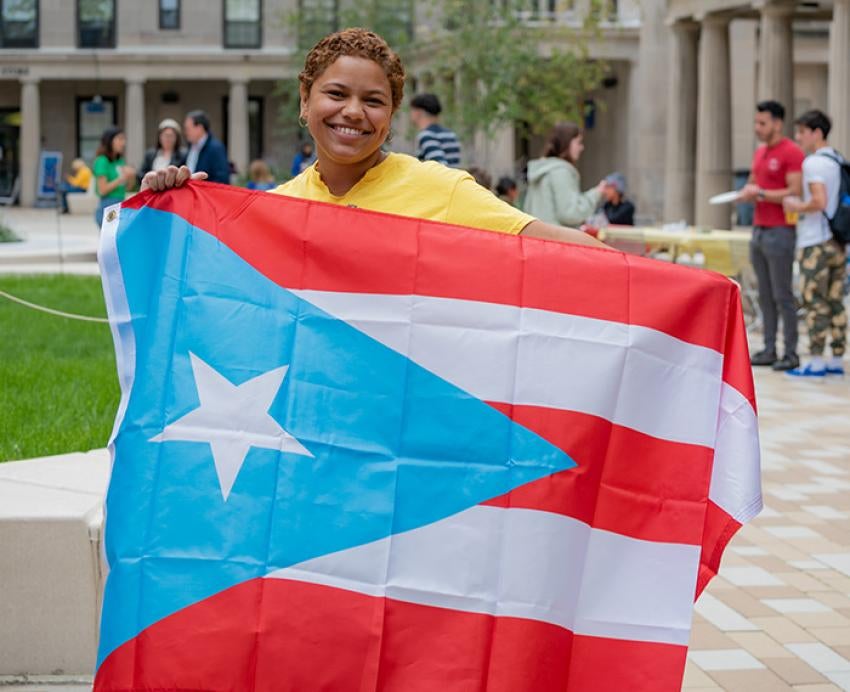 A person holds up a Puerto Rico flag